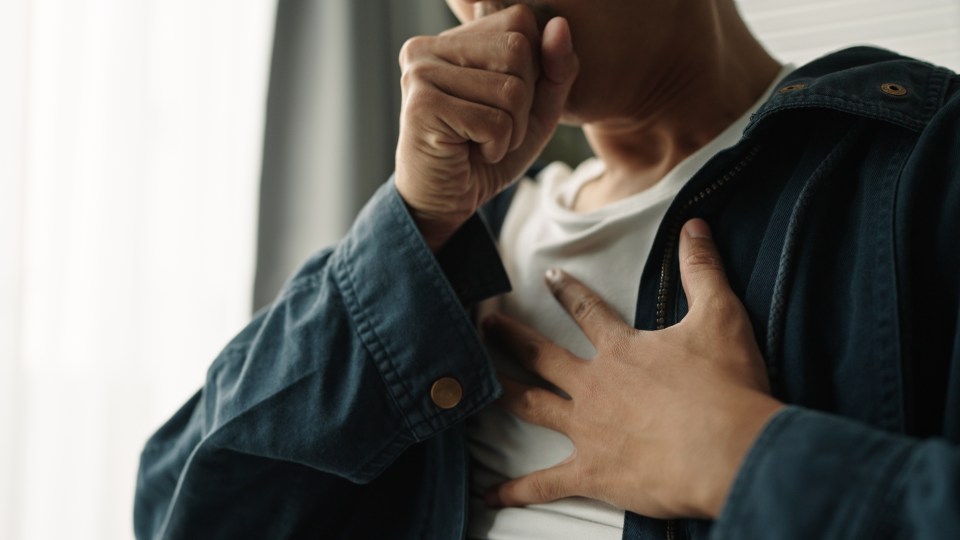 Young Asian man experiencing chest pain.