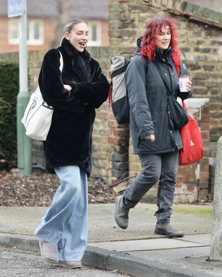 Zara McDermott walking and laughing with a friend.