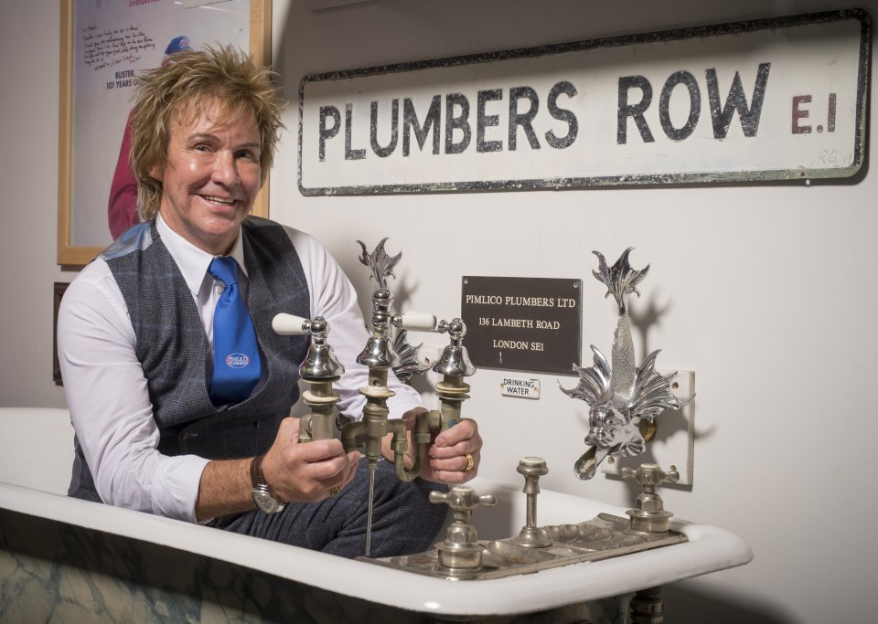 Charlie Mullins, managing director of Pimlico Plumbers, with antique plumbing fixtures.