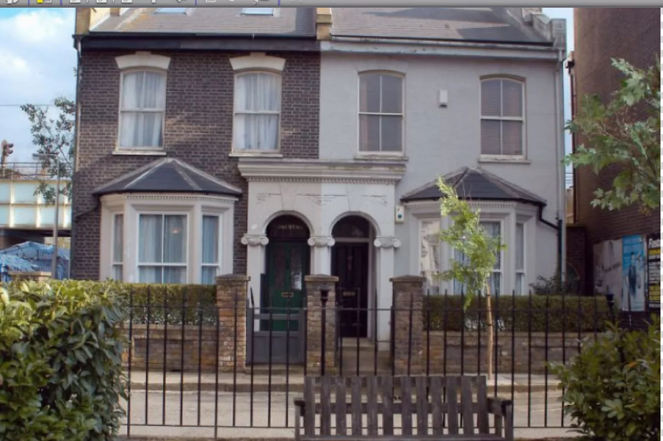 Semi-detached house with bay windows and a shared entrance.