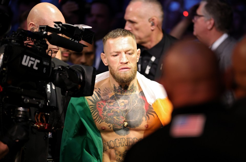 Conor McGregor walking through an arena before a UFC fight.