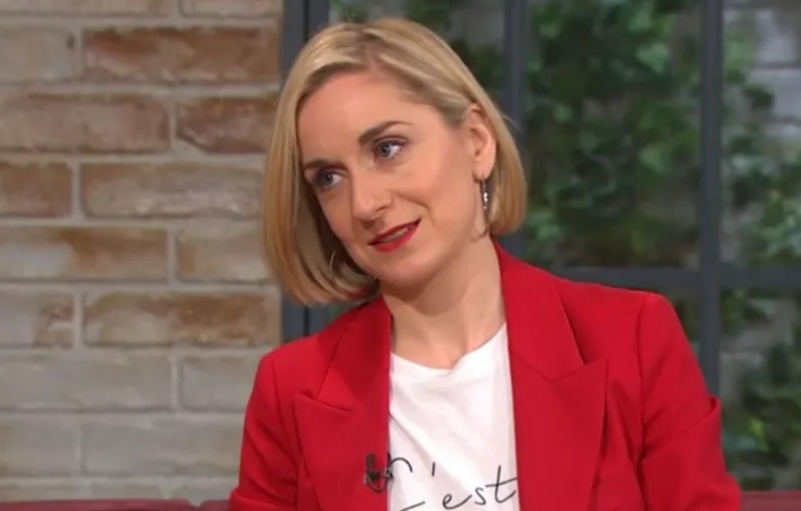 Woman in red blazer and white shirt.