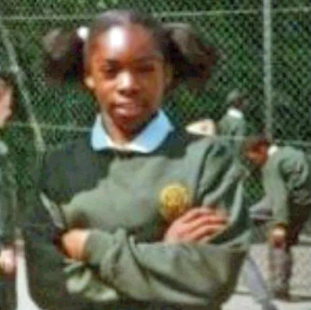 Photo of a young girl with her arms crossed.