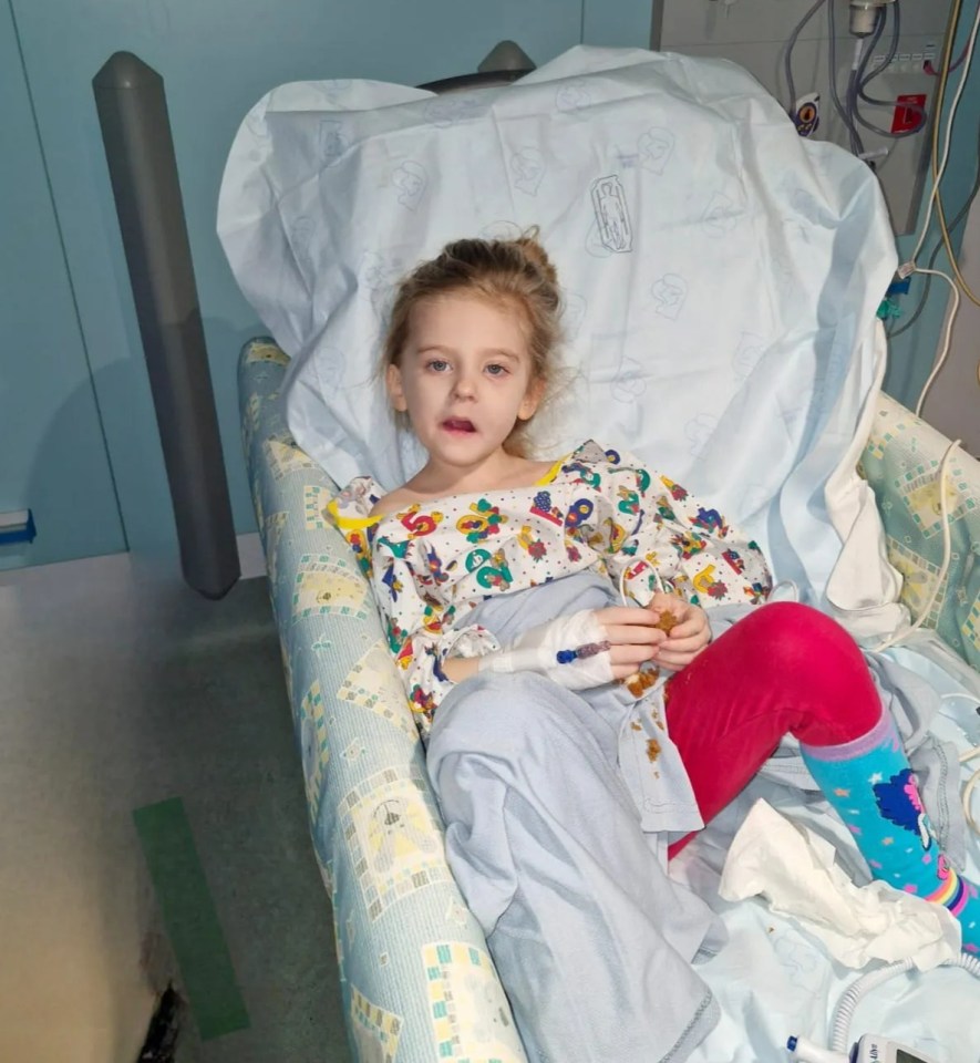 A young girl in a hospital bed.