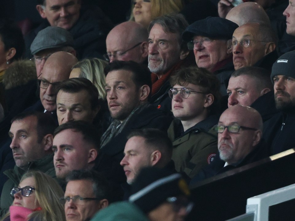 Sir Jim Ratcliffe, Sir Alex Ferguson, Sir David Brailsford, and Luke Littler in the stands at a Manchester United game.