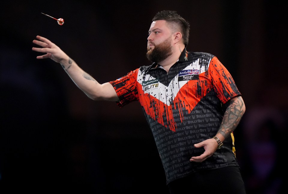 Michael Smith throwing a dart.