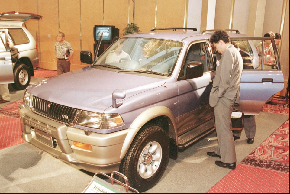 A purple Mitsubishi Challenger SUV at an auto show.