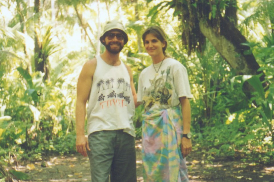 Photo of Tom and Eileen Lonergan in tropical foliage.