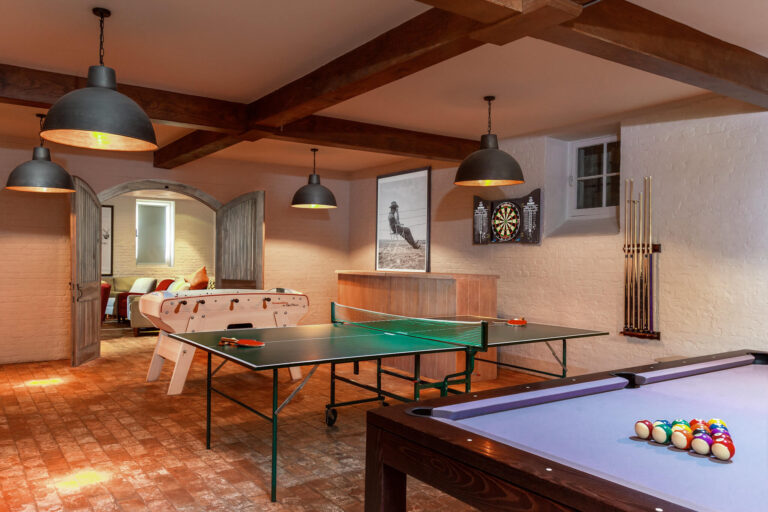 Game room with ping pong, foosball, and pool tables.