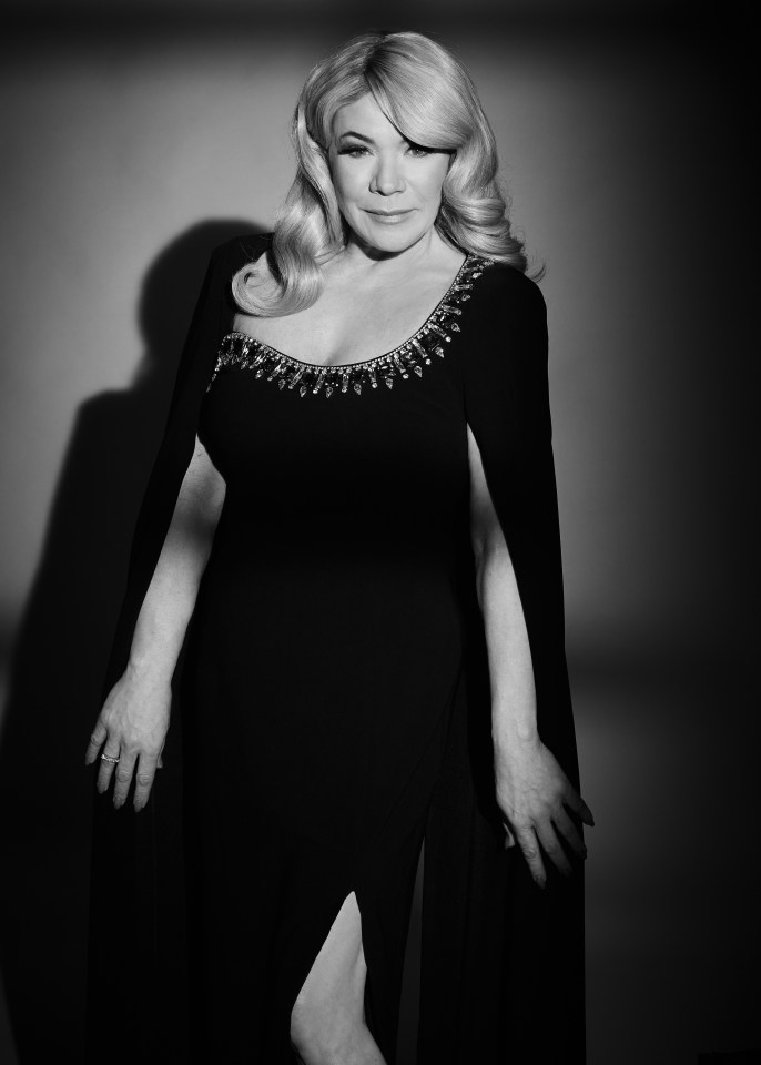 Black and white portrait of Gillian Taylforth in a black gown.