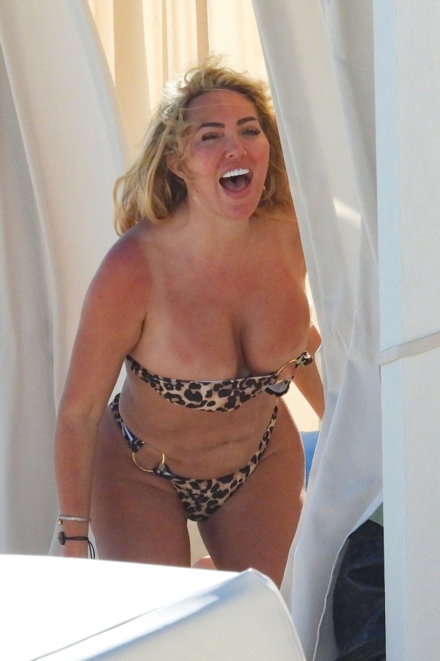 Aisleyne Horgan-Wallace in a leopard-print bikini on a beach.