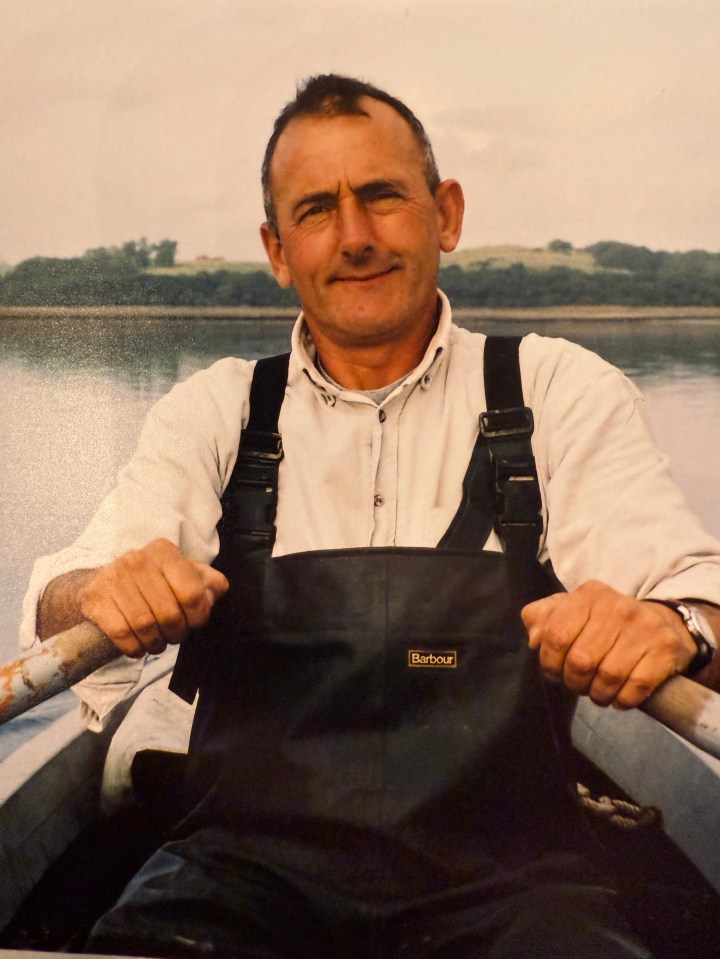 Photo of a man in a boat, wearing Barbour overalls.