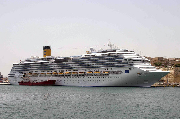 The Costa Concordia cruise ship docked in harbor.