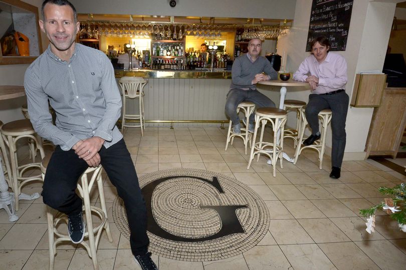 Three men at the opening of a restaurant.