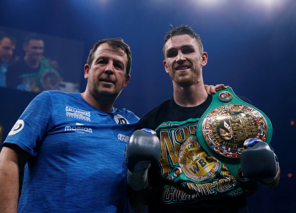 Callum Smith celebrates with his trainer after a boxing match.