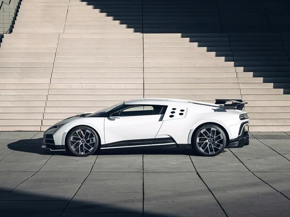 White Bugatti Centodieci parked in front of stairs.