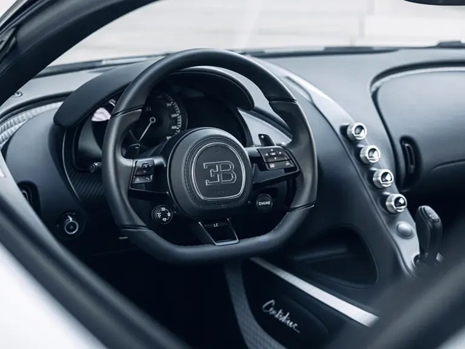 Close-up of a Bugatti Centodieci's interior, showing the driver's seat and steering wheel.