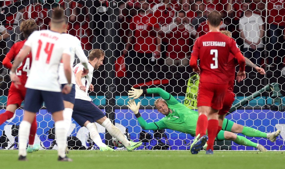 Harry Kane scoring a goal during a soccer match.