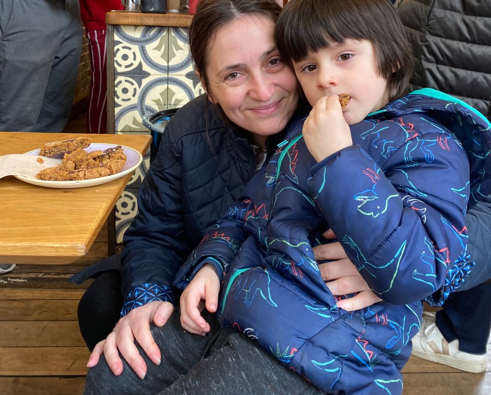 A mother and her young son eating cookies.