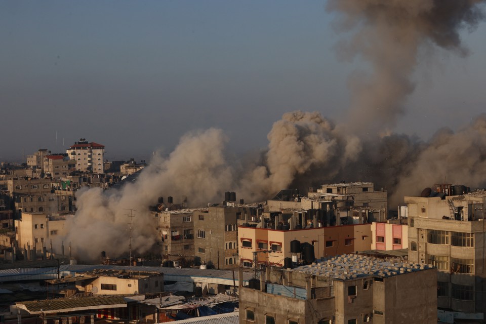 Smoke billows over Rafah buildings after an Israeli air raid.