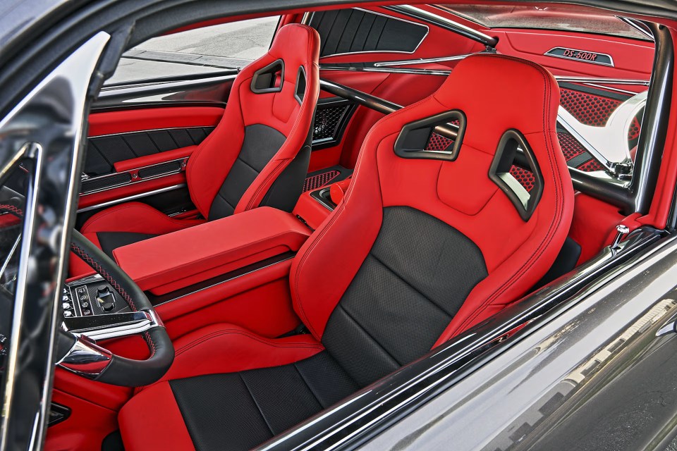 Interior view of a custom 1967 Ford Mustang Fastback with red leather seats.