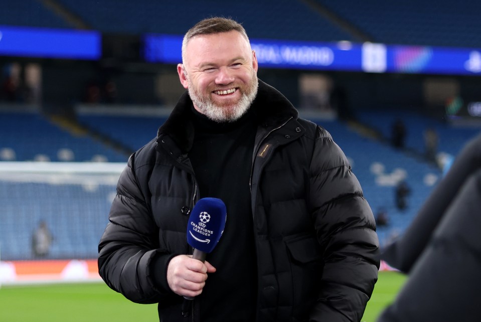 Wayne Rooney holding a Champions League microphone.