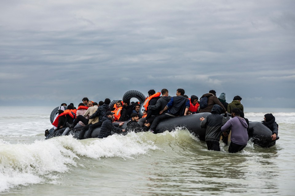 Migrants in an inflatable boat attempting to cross the English Channel.