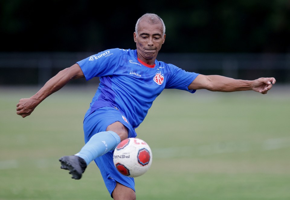 Romario, former soccer player, kicking a soccer ball during training.