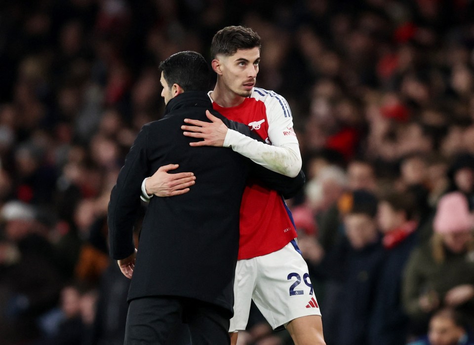 Arsenal's Kai Havertz hugging manager Mikel Arteta.