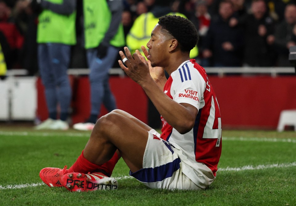 Arsenal's Myles Lewis-Skelly sits on the field.