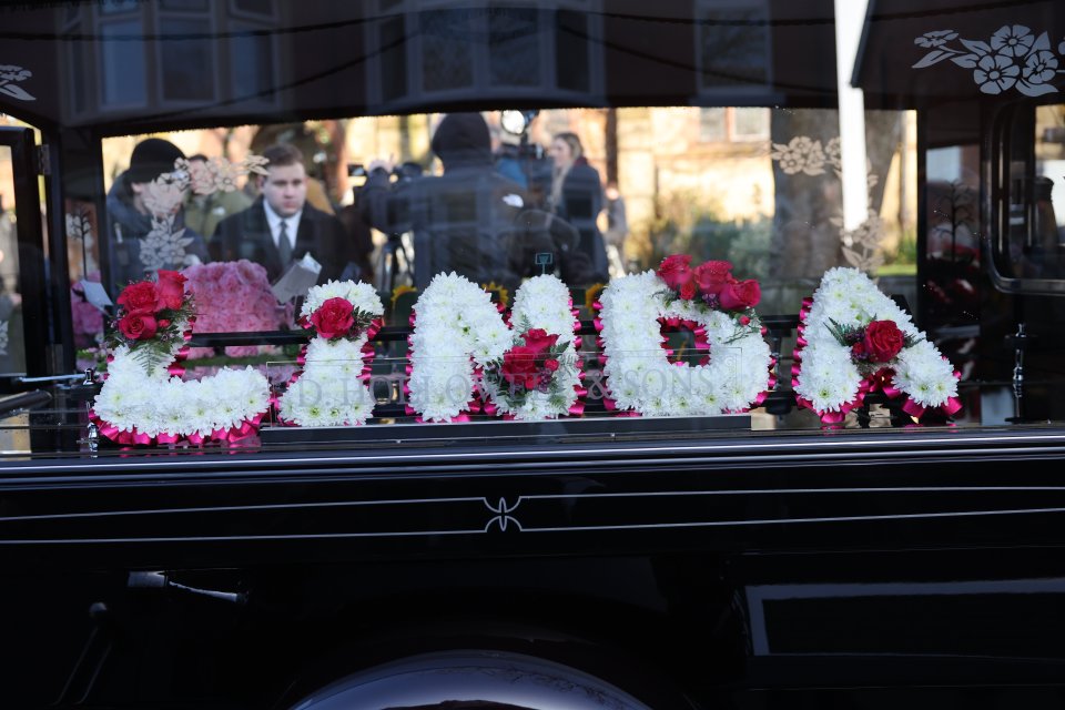 Floral tribute spelling LINDA on a hearse.