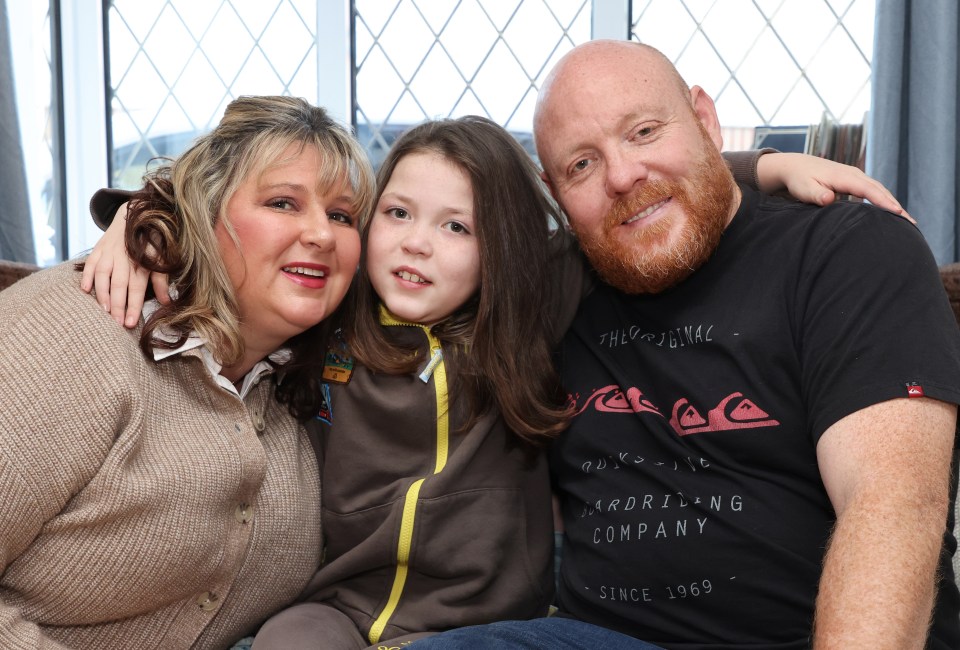 A nine-year-old girl with her parents.