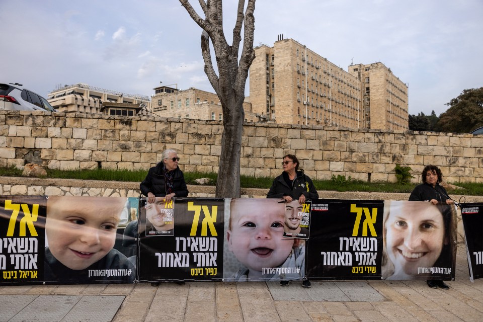 Protestors holding signs with photos of Israeli hostages outside the Prime Minister's office in Jerusalem.