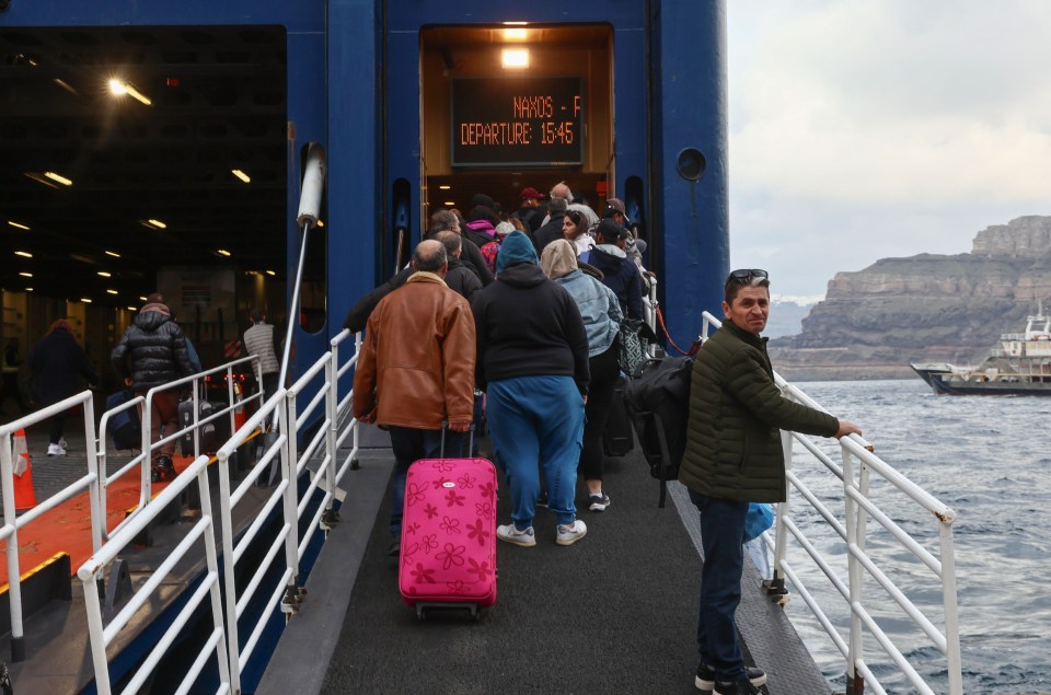 Tourists and residents evacuating Santorini by ferry.