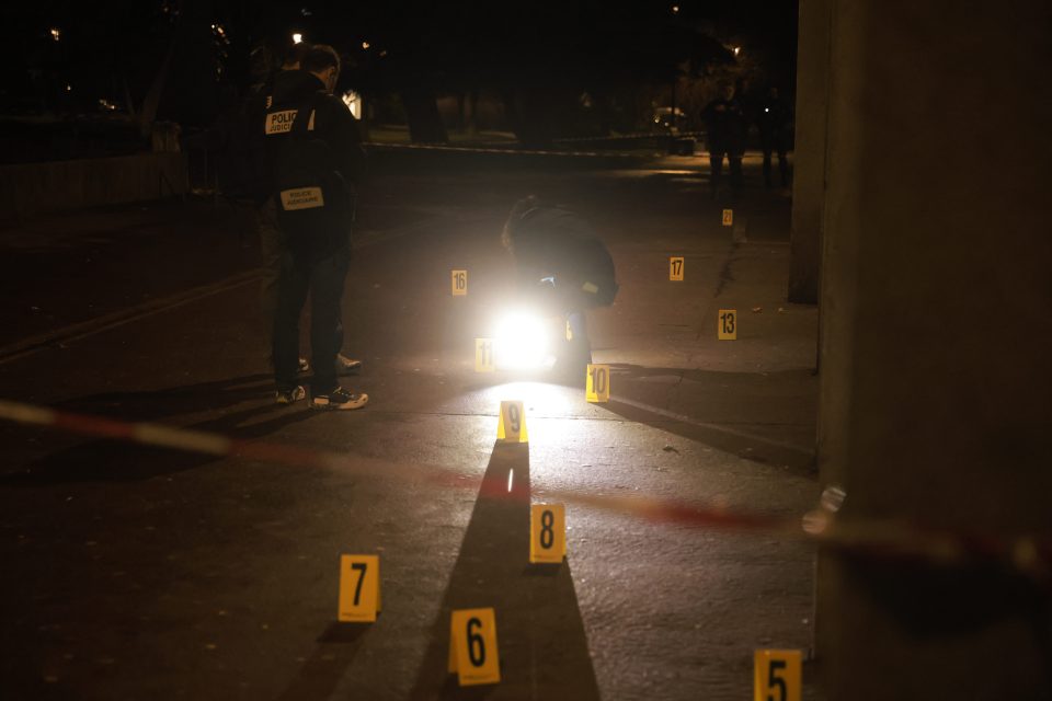 Police investigators at a nighttime crime scene.