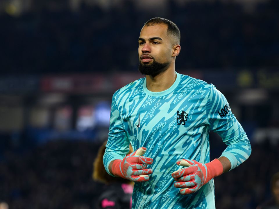 Chelsea's Robert Sanchez in teal goalkeeper jersey.