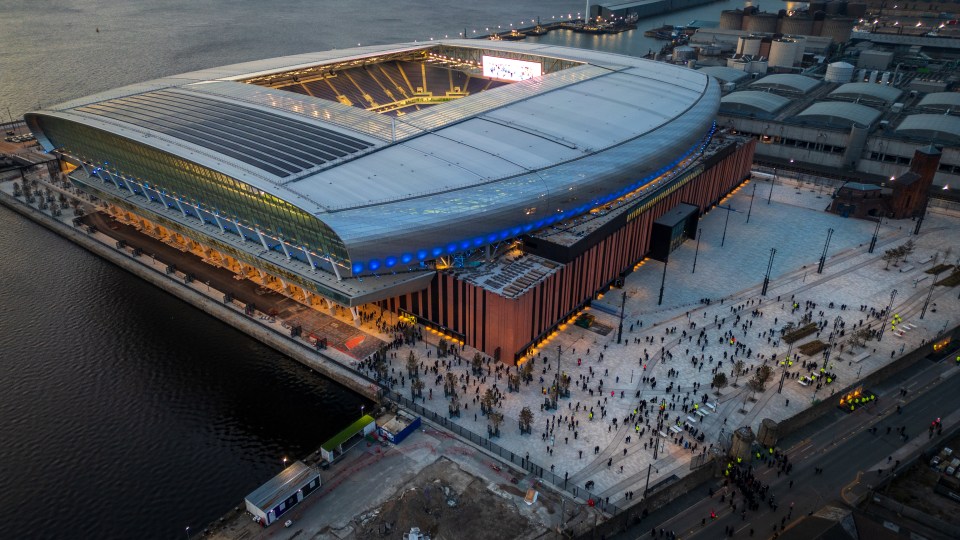 Aerial view of Everton's new stadium at Bramley-Moore Dock in Liverpool, with fans arriving for a friendly match.