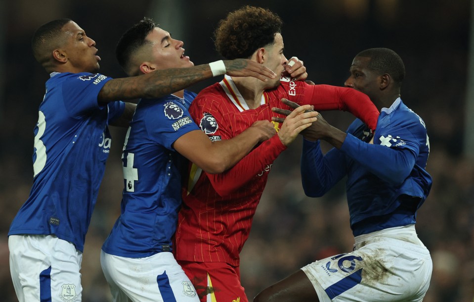 Liverpool's Curtis Jones and Everton players clashing after a soccer match.