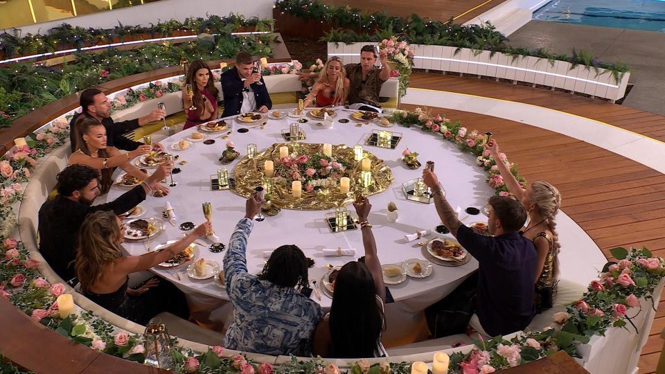 Islanders at a dinner party toasting.