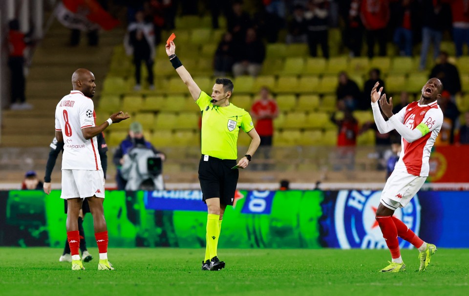 Soccer referee showing a red card to a player.