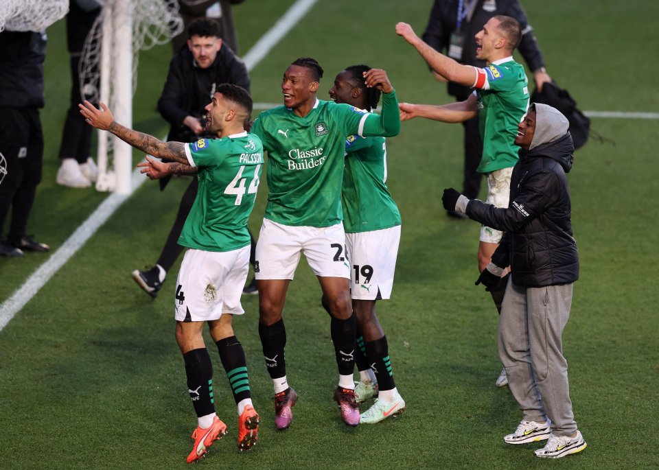 Plymouth Argyle players celebrating at the final whistle.