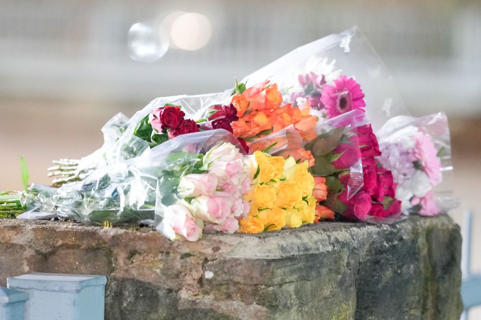 Flowers left near a school following a stabbing.