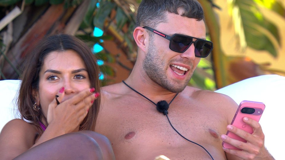 Tina and Chuggs from Love Island reacting to something on a phone.