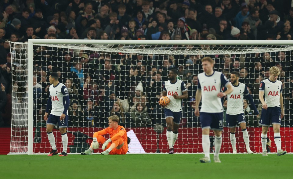 Tottenham Hotspur players look dejected after a goal.