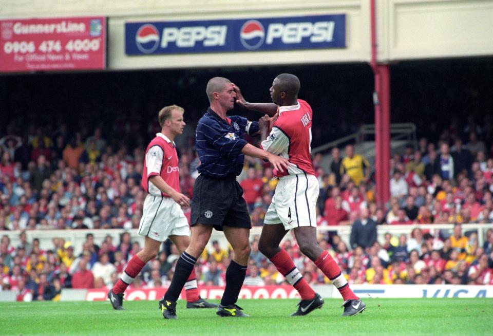 Roy Keane and Patrick Vieira confronting each other on a football pitch.