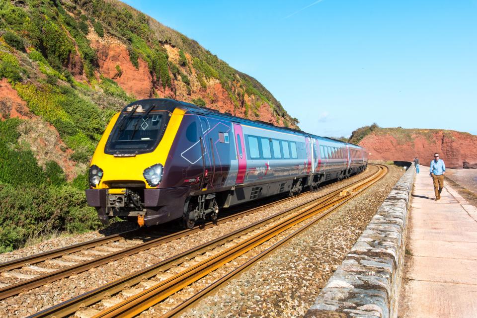 High-speed train traveling along a coastal railway.