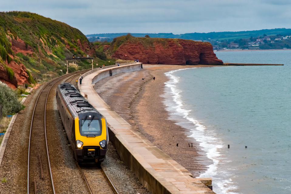 Train traveling along a coastal railway line.