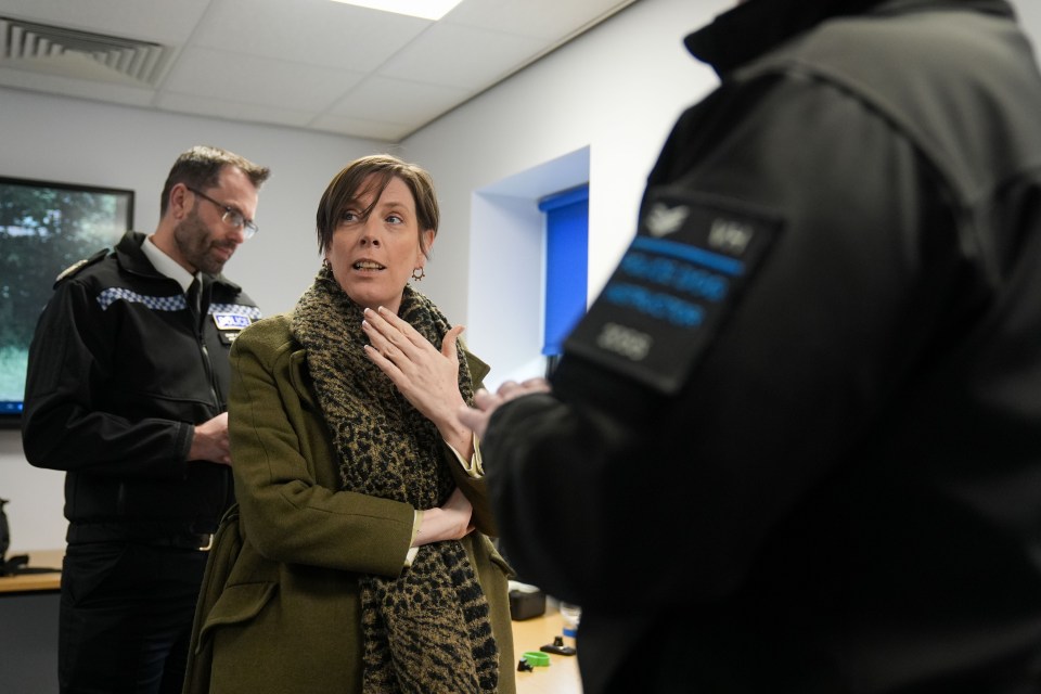 Jess Phillips, Minister for Safeguarding and Violence Against Women and Girls, speaks with police officers.