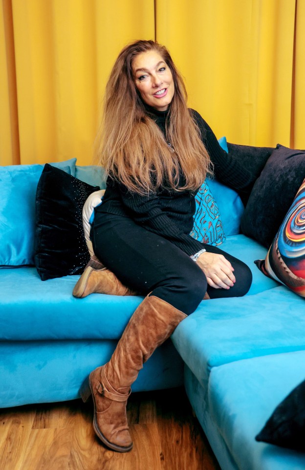 Woman sitting on a blue couch.