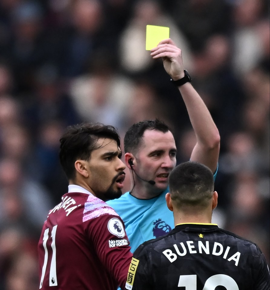 Referee showing a yellow card to a soccer player.